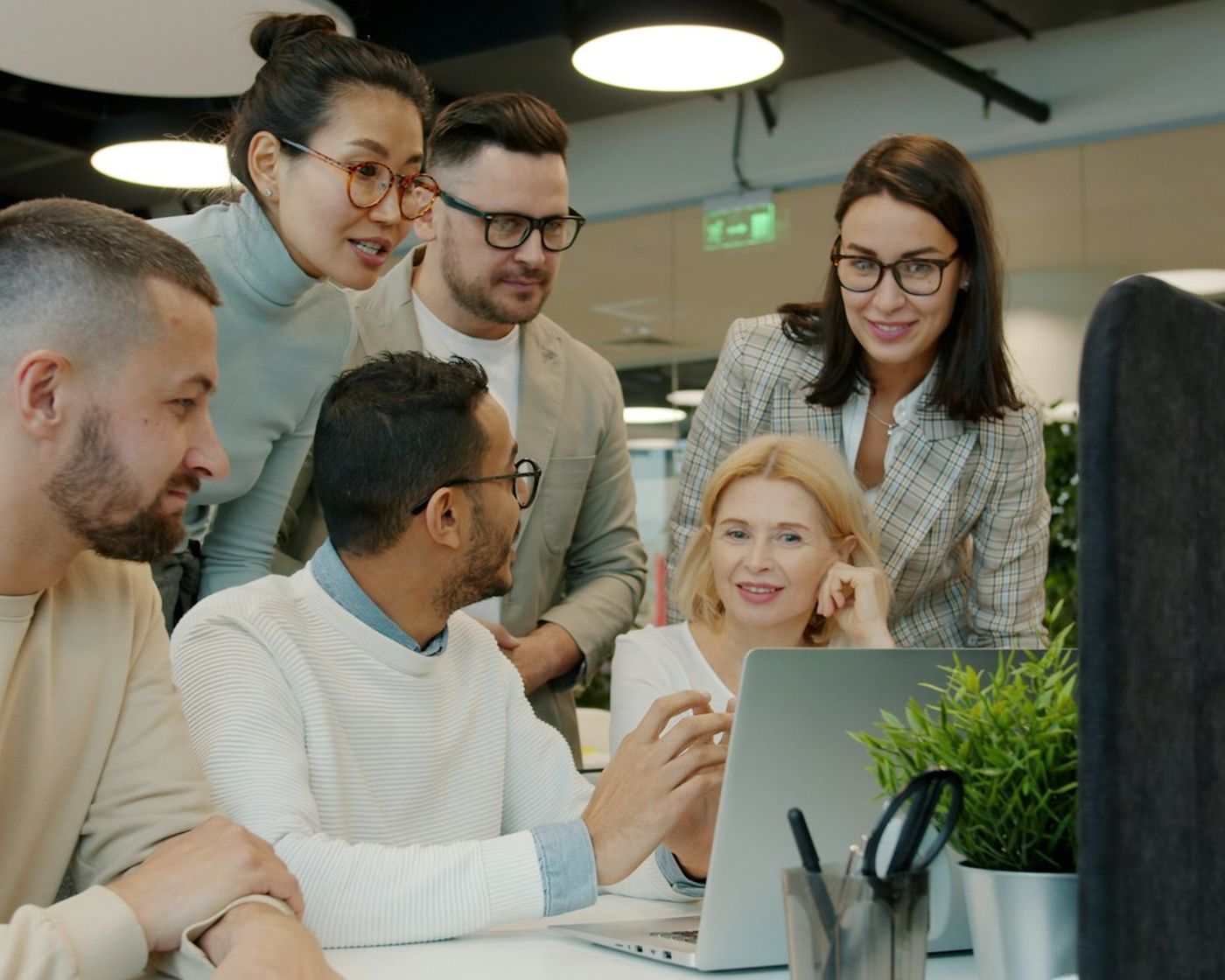 The AMP team gathered around a laptop